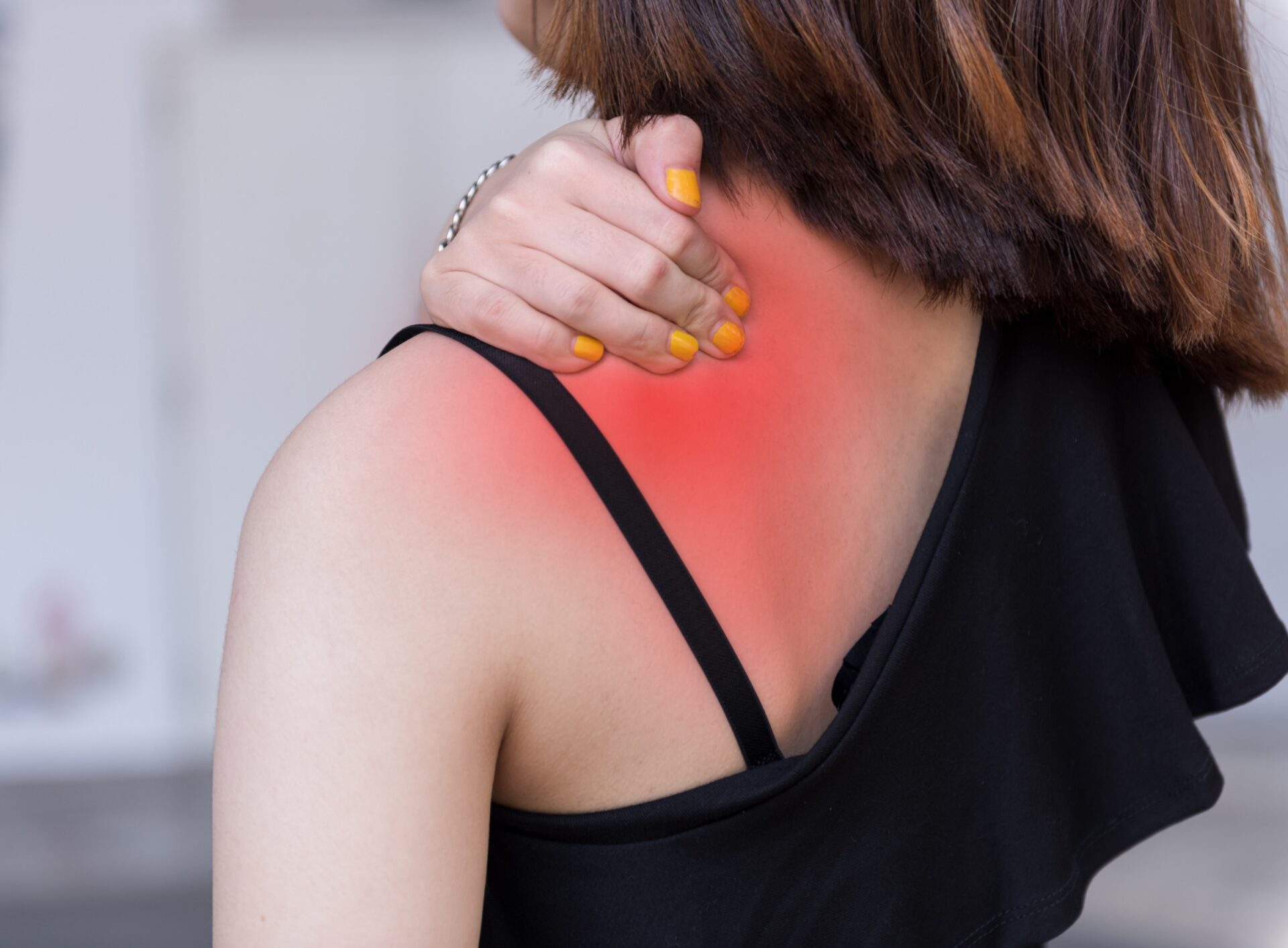 Asian woman having a neck pain, stiffness, injury on shoulder and neck,chronic pain